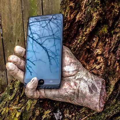 severed zombie hand phone holder